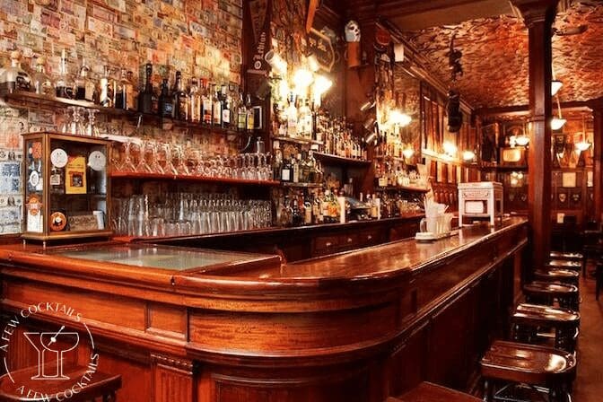 Classic wooden bar with warm lighting and ornate decor.